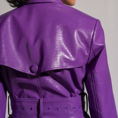 Perfect for transitioning between seasons, this Purple Leather Jacket effortlessly pairs with both casual and dressed-up outfits. Whether you're heading to a social event, a night out, or simply want to add a touch of edge to your everyday style, this jacket is a versatile and chic option.  Pair it with your favourite jeans for a chic and casual vibe or throw it over a dress to add an element of edge to your ensemble. Versatile and stylish, this jacket is a must-have for those who want to infuse Fitted Belted Evening Outerwear, Fitted Belted Outerwear For Evening, Spring Fitted Belted Leather Jacket, Fitted Faux Leather Belted Outerwear, Fitted Long Coat In Faux Leather, Fitted Faux Leather Long Coat, Trendy Fitted Leather Jacket With Lapel Collar, Fitted Long Faux Leather Coat, Party Outerwear With Double Button Closure And Lapel Collar