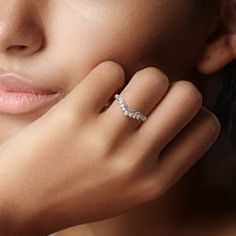 a close up of a woman wearing a diamond ring