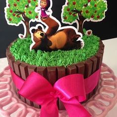 a birthday cake decorated with an image of a bear and apple tree on top of it