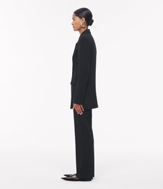 Crafted in a soft bonded jersey and precisely tailored with a satin finish inside. Featuring a concealed side zipper and pleating that creates a clean and elongating silhouette. Sits at the natural waist. Complete the suit by pairing with the Jersey Pant. The viscose in this garment is made using wood pulp sourced from an FSC certified supplier, committed to promoting sustainable forest management and the protection of ancient and endangered forests. The small addition of elastane helps to impro Sleek Semi-formal Pantsuit With Pressed Crease, Sleek Fitted Pantsuit With Structured Boning, Tailored Sleek Pantsuit With Suit Collar, Sleek Tailored Pantsuit With Lapel Collar, Sleek Tailored Pantsuit With Suit Collar, Tuxedo-style Structured Business Pantsuit, Structured Tuxedo Pantsuit For Business, Structured Tuxedo-style Business Pantsuit, Structured Tuxedo Style Business Pantsuit