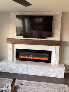 a flat screen tv mounted above a fireplace