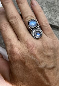 Two moonstones set in solid sterling silver with an antiqued finish. I have a few of these gorgeous moonstones in stock for custom orders. These stones are absolutely stunning and even prettier in person. This ring measures a little under 1 inch from top to bottom. The moonstones are 10 and 7mm in size. The band is 6mm wide. Feel free to contact me with any questions or comments. Ring size. Made to order in your size. Silver Moonstone Ring Stamped 925, Hand Forged Moonstone Ring In Sterling Silver, Silver Moonstone Crystal Ring In Moon Shape, Mystical Sterling Silver Moonstone Ring With Moon Phase, Unique Moonstone Ring With Moon Phase, Spiritual Sterling Silver Moonstone Ring With Moon Phase, Silver Moonstone Ring With Moon Phase, Celestial Style Silver Moonstone Ring, Hand-forged Silver Round Moonstone Ring