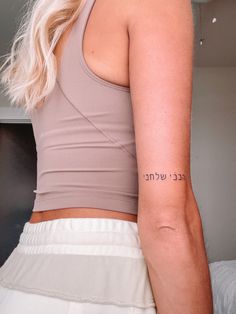 a woman with a tattoo on her arm