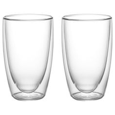 two clear glasses sitting next to each other