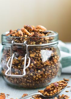 a glass jar filled with granola on top of a table