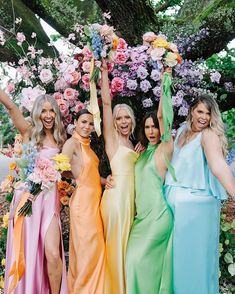 the bridesmaids are all wearing different colored dresses