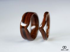 two wooden wedding rings on a white background