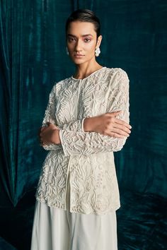 Ivory short jacket with all over floral jaal pattern, tonal beads, cut dana and pearl embroidery. Paired with flared palazzo. - Aza Fashions Hand Embellished Long Sleeve Blouse For Wedding, Long Sleeve Tops With Intricate Embroidery For Wedding, White Embellished Outerwear For Wedding, Long Sleeve Blouse With Pearl Embroidery For Wedding, Pearl Embroidered Long Sleeve Wedding Outerwear, Long Sleeve Wedding Blouse With Pearl Embroidery, Long Sleeve Embellished Wedding Tops, Embellished Long Sleeve Wedding Top, Elegant Outerwear With Intricate Embroidery For Reception