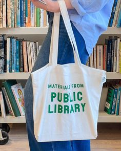 model holding white tote with 'materials from public library' in kelly green Mushroom Culture, Library Tote Bag, A Farewell To Arms, Library Tote, Design Library, Wood Book, Loose Change, Summer Books, Everyday Tote