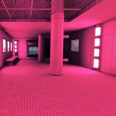 an empty room with pink lighting in it