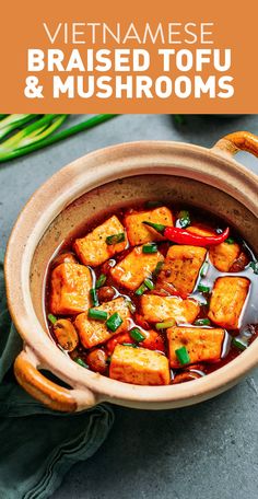 a bowl filled with tofu and vegetables on top of a table