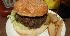 a hamburger and french fries on a white plate