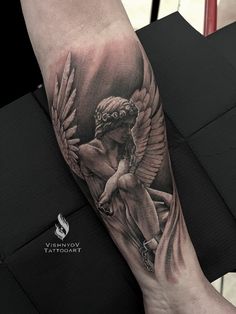 a woman's arm with an angel tattoo on the left side of her leg