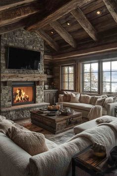 a living room filled with furniture and a fire place in the middle of a room