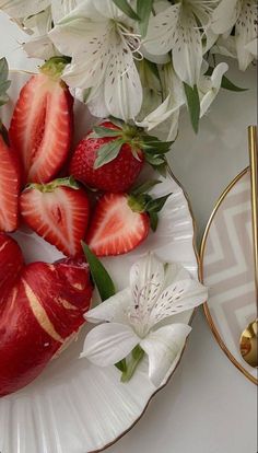 strawberries and white flowers on a plate