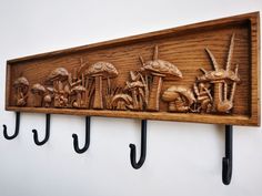 a wooden wall mounted with hooks and mushrooms