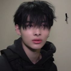 a young man with black hair and piercings