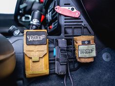 the interior of a car with three different items in its pocket and one on the floor