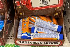 an open suitcase with sunscreen lotion and toothpaste in it on display