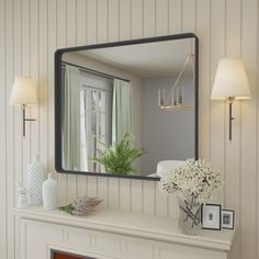 a fireplace with a mirror on the mantle above it and a vase filled with flowers