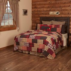 a bed in a bedroom next to a window with a bear sign on the wall