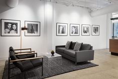 a living room filled with furniture and pictures on the wall