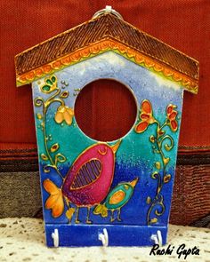 a painted birdhouse sitting on top of a table