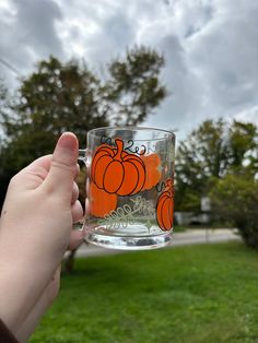 Enjoy your morning coffee or tea with this charming pumpkin mug! Perfect to add to your own cup collection or gift to a Halloween loving friend!  Mug details: Large and comfortable handle 12 oz capacity Easy to clean Durable Perfect for warm of cold drinks Made with durable permanent vinyl Cup care:  NOT microwave safe NOT dishwasher safe Hand wash only Do not scrub or soak Colors may appear slightly different on different devices, if you are unsure of the color feel free to reach out!  Returns Fall Iced Coffee, Pumpkin Mug, Fall Mug, Spooky Gifts, Halloween Cups, Iced Coffee Cup, Glass Mug, Cup Coffee, Halloween Mug