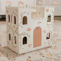 a toy house made out of cardboard sitting on top of a counter