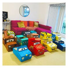 a room filled with lots of different colored boxes on top of floor next to a couch