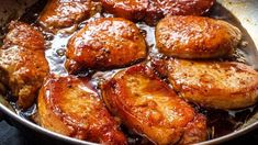 some chicken is cooking in a pan on the stove top and it looks like they have been cooked