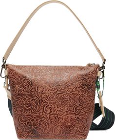 The little sister to the Hobo bucket bag, our Wedge is great to store all your essentials. This bag’s interior pockets and roomy layout make it easy to hold everything you need- by your side with the crossbody strap or on hand with the leather shoulder strap. Sally tooled leather exterior Includes a leather luggage tag secured with a hand-woven friendship bracelet Interior open pocket, zipper pocket, and 2 credit card slots Includes two straps: a leather shoulder strap (9 1/2" drop) and a woven Pura Vida Necklace, Terry Cloth Headband, Leather Luggage Tag, Tiny Charm, Leather Luggage Tags, Everyday Tote, Leather Luggage, Stylish Clothes For Women, Mini Wallet