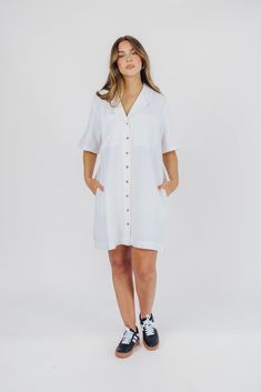 Easy, breezy, and utterly charming, this button-up swing dress is sheer perfection. Style it with sneakers or slides for the easiest outfit ever - the Kristen is perfect for travel, touring, or running errands and chasing little ones! FIT: Runs true to size - relaxed fit. MATERIAL: GARMENT DETAILS: ﻿Relaxed button-up swing dress, with 1/2 length sleeves, V-neckline, and full front button placket. SIZE GUIDE: XS (0-2) / S (2-4) / M (6-8) / L (10-12) MODEL DETAILS: Mackenzie - Size S Heather - Siz Casual Button-up Shirt Dress For Day Out, Casual White Shirt Dress With Buttons, Summer Mid-length Shirt Dress With Button Closure, Flowy Button-up Shirt Dress In Casual Style, Casual Knee-length Shirt Dress For Summer, Casual Shirt Dress For Daywear, Summer Mid-length Shirt Dress With Buttons, Casual Collared Dresses For Vacation, Casual Knee-length Shirt Dress For Vacation