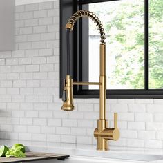 an image of a kitchen setting with gold faucet and white brick wall in the background