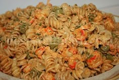 a bowl filled with pasta and vegetables on top of a table