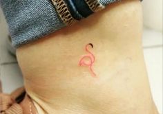 a woman's stomach with a small pink tattoo on her lower leg and foot