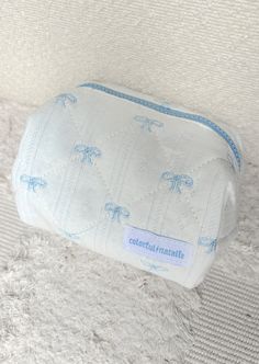 Embroidered blue bow makeup bag Blue zipper detailing Dimensions: 7" x 4" x 4" Cute Blue Cosmetic Bag For School, Cute Blue Pouch For Personal Use, Cute Blue Cosmetic Bag, Cute Blue Rectangular Pouch, Blue Pouch Cosmetic Bag For On-the-go, Crop Top Sweatshirt, Long Sleeve Outerwear, Slipper Socks, Blue Bow