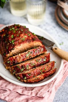 sliced meatloaf on a plate with a knife