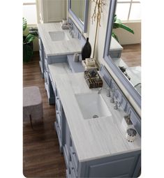 a bathroom with double sinks and mirrors in it