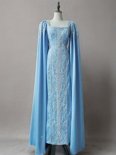 Step into sophistication with the Light Blue Beaded Formal Dress with Cape Sleeves. This elegant evening gown is adorned with intricate beadwork and pretty sequins that catch the light, adding a dazzling touch to your look. The unique cape sleeves drape gracefully, creating a regal and timeless silhouette. The fitted bodice, featuring exquisite beaded details, enhances the luxurious appeal of the dress. The square neckline adds a classic and refined touch, while the full-length design ensures you make a memorable entrance at any formal event. Perfect for those who seek a blend of elegance and grandeur, this gown provides a flattering fit that accentuates your curves and offers all-night comfort. Shine brightly in this stunning light blue beaded gown and create unforgettable moments. Light Blue Fitted Dress, Blue Gowns Elegant, Snowflake Gown, Formal Dress With Cape, Blue Night Dress, Evening Gown Plus Size, Elvish Dress, Dress With Cape Sleeves, Royal Gowns