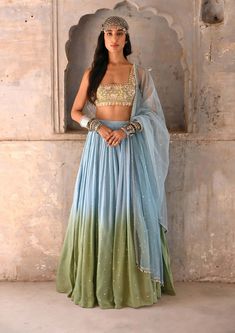 Editor's Note Step into elegance with this basil green ombre resham zardozi and glass-beads embroidered blouse, beautifully crafted with intricate detailing. Paired with a shaded georgette skirt and a tulle dupatta, this ensemble exudes grace and charm. The ombre effect adds a touch of sophistication, while the resham, Blue Green Ombre Dress, Ombre Indian Outfit, Colorful Blouse Outfit, Blue And Green Clothes, Lengha Green, Ombre Dupatta, Desi Fits, Georgette Skirt, Beads Embroidery