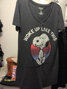 a t - shirt that says woke up like this hangs on a rack in a closet