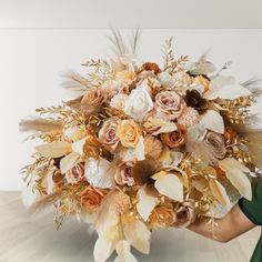 a woman holding a large bouquet of flowers