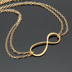 "This \"INFINITY\" necklace symbolizes never ending love (or friendship)for \"LOVE\" is infinite, ageless and boundless. A romantic large Infinity (figure eight) charm is the focal of this necklace on 24K Vermeil and it hang from a double strand gold filled chain. ♥ 30x12mm large INFINITY charm on 24K VERMEIL* (*98.5% pure gold over Sterling Silver). ♥ Double strand dainty cable chain, secured with 5mm spring ring clasp and embellished with 3mm Swarovski crystals or freshwater rice pearls (or 2m Gold Infinity Necklace, Infinity Necklace Gold, Double Chain Necklace, Infinity Charm, Infinity Jewelry, Infinity Necklace, Mothers Day Presents, Double Chain, Matching Bracelets