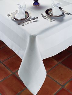 the table is set with silverware and napkins