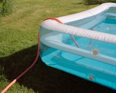 an inflatable swimming pool with a hose attached to it