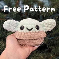 a hand holding a small toy with the words free pattern on it and an image of a