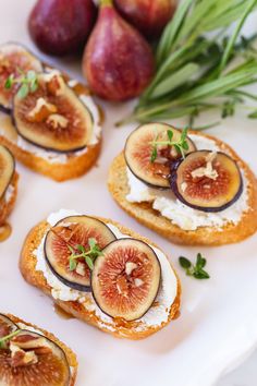 figs and cream cheese on toasted bread with fresh herbs for garnish