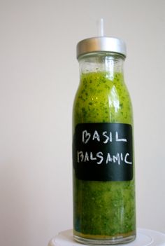 a jar filled with green pest sitting on top of a white table