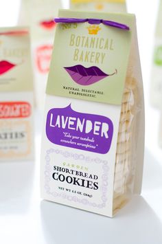 some cookies are sitting on a table with labels attached to the packages and tags around them